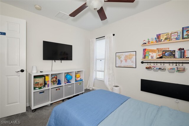 bedroom featuring ceiling fan and dark carpet