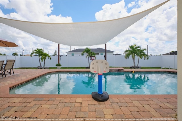 view of swimming pool with a fenced in pool, a fenced backyard, and a patio