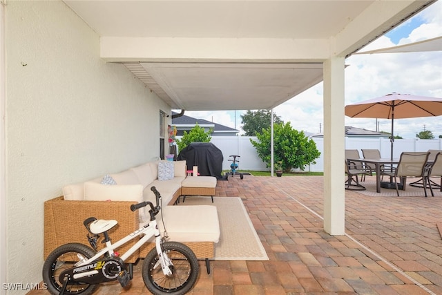 view of patio / terrace with grilling area, a fenced backyard, an outdoor living space, and outdoor dining space