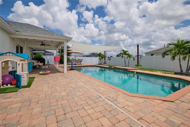 view of swimming pool featuring ceiling fan and a patio area