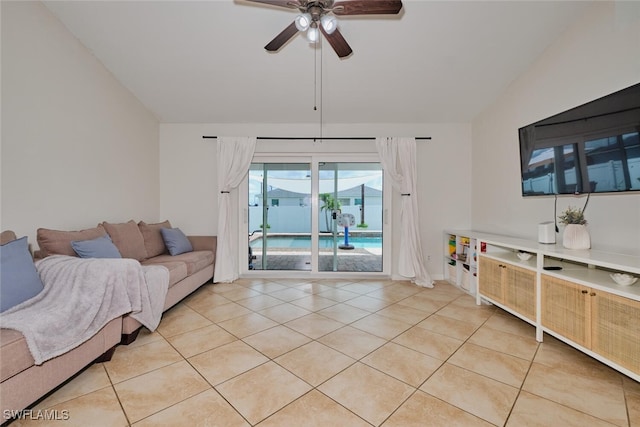 living room featuring ceiling fan, light tile patterned flooring, and vaulted ceiling