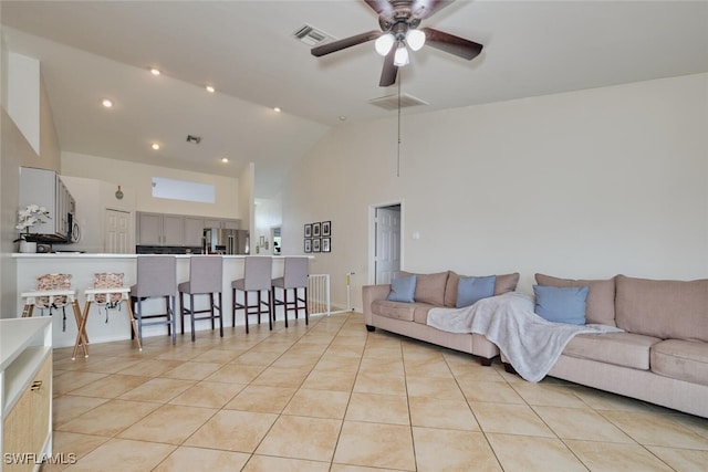 tiled living room with high vaulted ceiling and ceiling fan