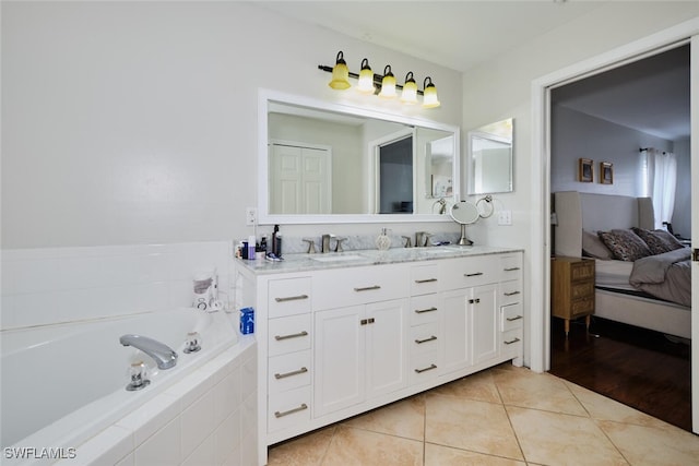 bathroom featuring vanity, tiled bath, and tile patterned floors