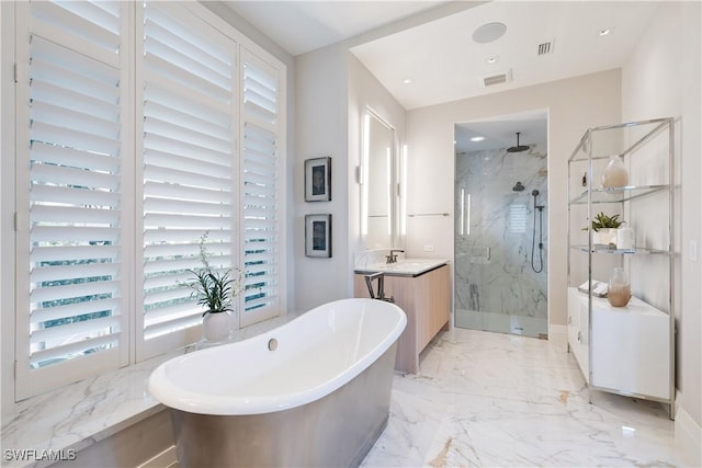 bathroom with marble finish floor, a marble finish shower, visible vents, vanity, and a freestanding tub