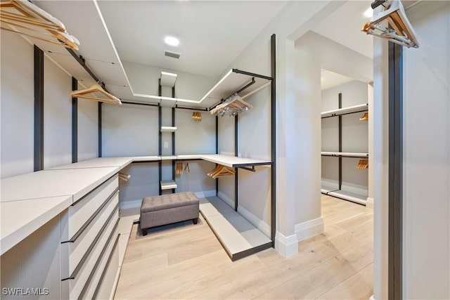 spacious closet featuring light wood finished floors and visible vents