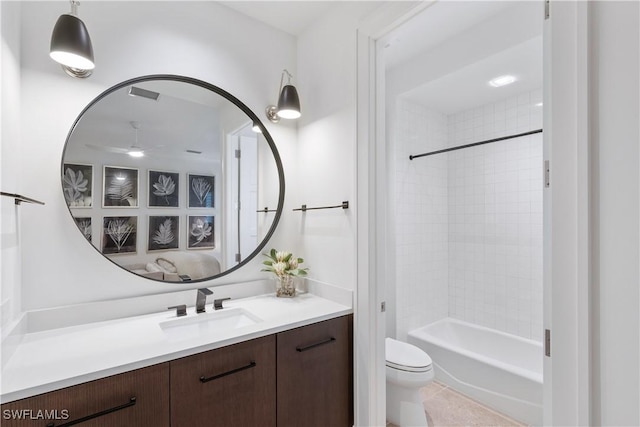 bathroom featuring toilet, ceiling fan, tile patterned flooring, bathtub / shower combination, and vanity