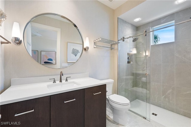 bathroom featuring vanity, a shower stall, and toilet