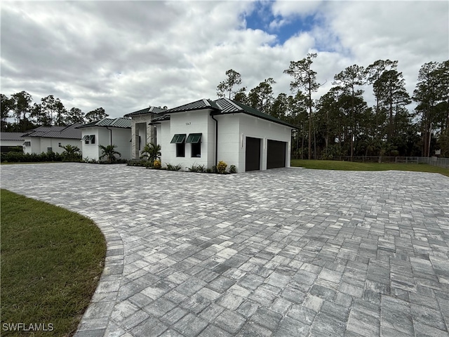 view of front of house with a front yard and a garage