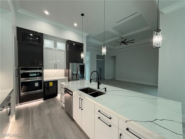 kitchen featuring sink, white cabinets, stainless steel appliances, and light hardwood / wood-style floors