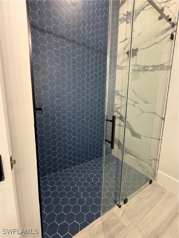 bathroom featuring a shower with door