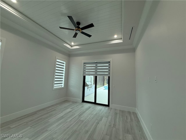 unfurnished room with light hardwood / wood-style flooring, a raised ceiling, ceiling fan, and wood ceiling