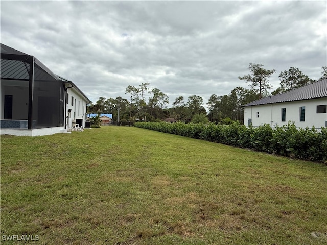 view of yard with a lanai