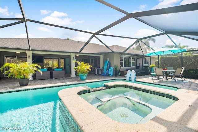 view of swimming pool with an in ground hot tub, a patio, and glass enclosure