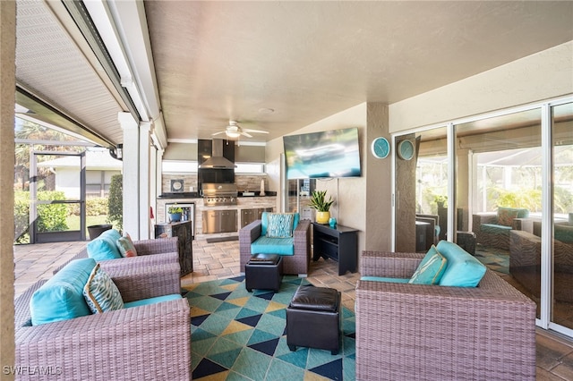 view of patio / terrace featuring an outdoor living space, area for grilling, a lanai, and exterior kitchen