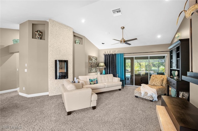 living room featuring carpet floors, a large fireplace, vaulted ceiling, and ceiling fan