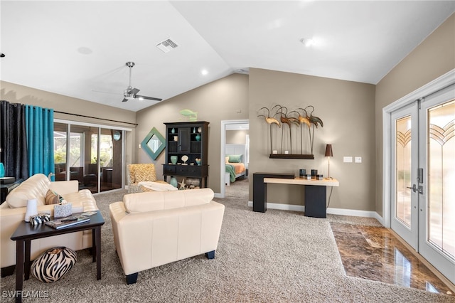 carpeted living room with ceiling fan, vaulted ceiling, and french doors