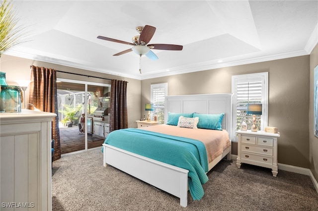 bedroom with access to exterior, ceiling fan, crown molding, a tray ceiling, and dark carpet