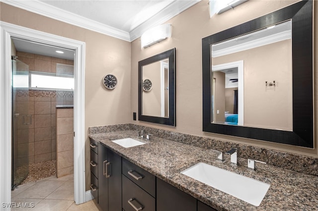 bathroom featuring tiled shower, vanity, tile patterned floors, and crown molding