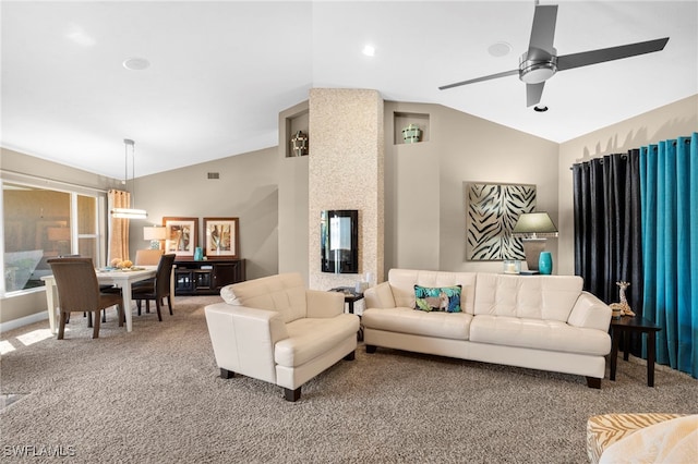 carpeted living room with ceiling fan and vaulted ceiling