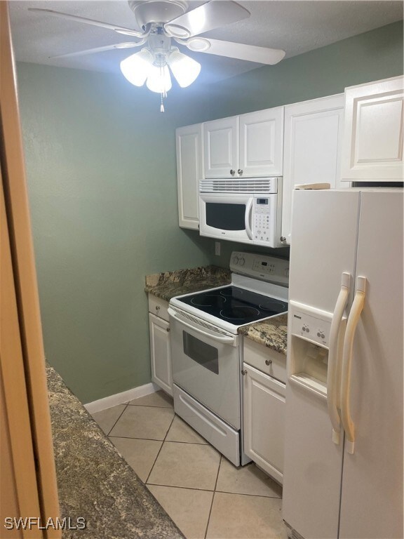 kitchen with white cabinets, white appliances, and ceiling fan