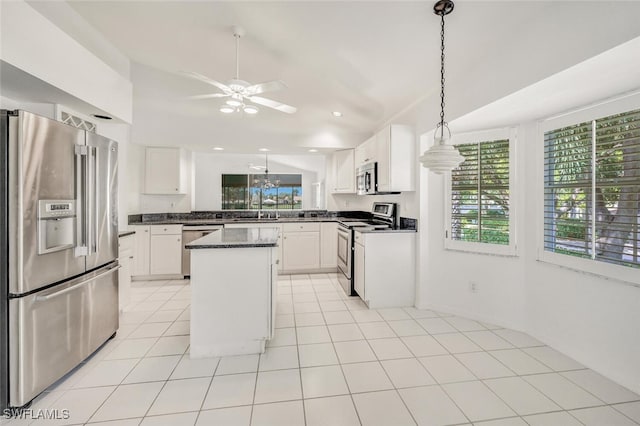 kitchen featuring a center island, white cabinets, ceiling fan, and stainless steel appliances