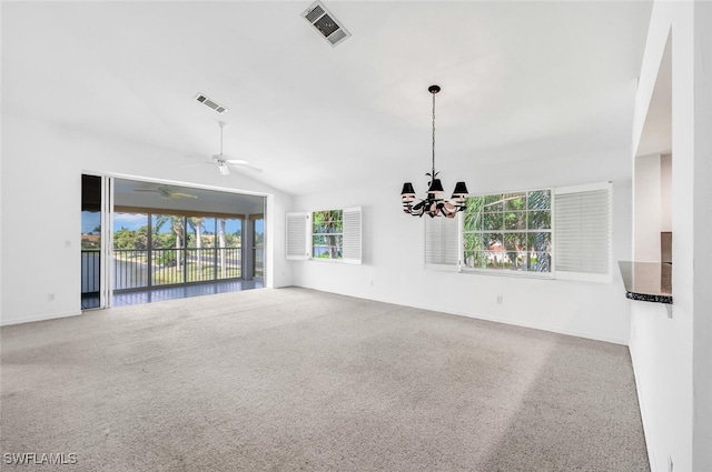 unfurnished living room with vaulted ceiling, ceiling fan with notable chandelier, and carpet floors