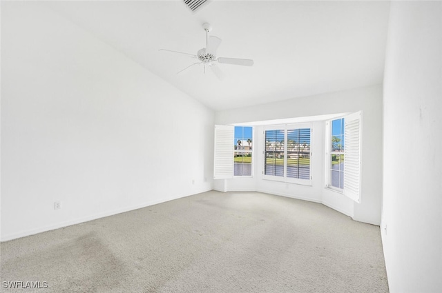 spare room with lofted ceiling, ceiling fan, and carpet