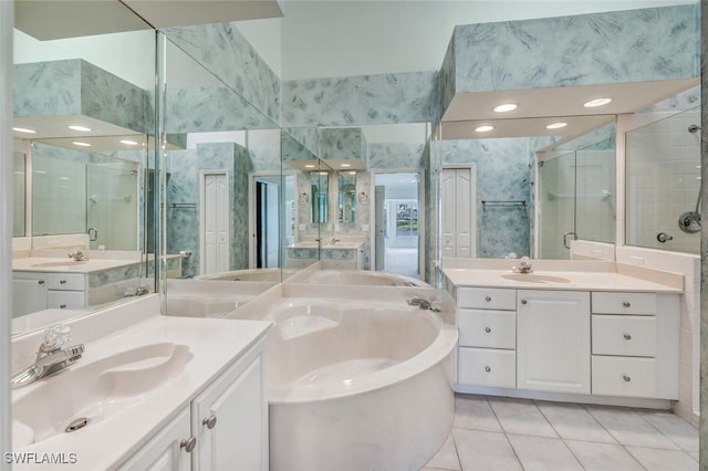 bathroom featuring tile patterned flooring, independent shower and bath, and vanity