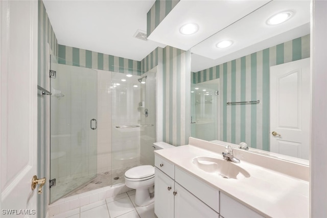 bathroom featuring vanity, toilet, tile patterned floors, and walk in shower