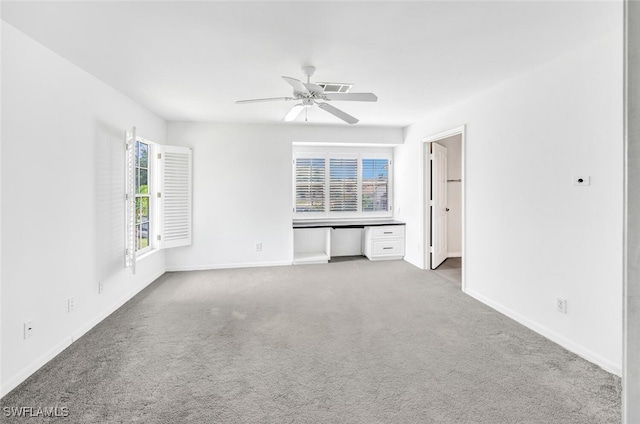 unfurnished living room featuring ceiling fan and light carpet