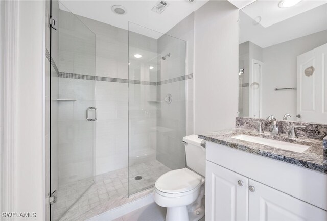 bathroom with vanity, toilet, and walk in shower