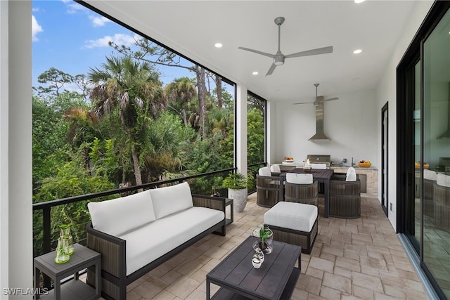 sunroom / solarium featuring ceiling fan