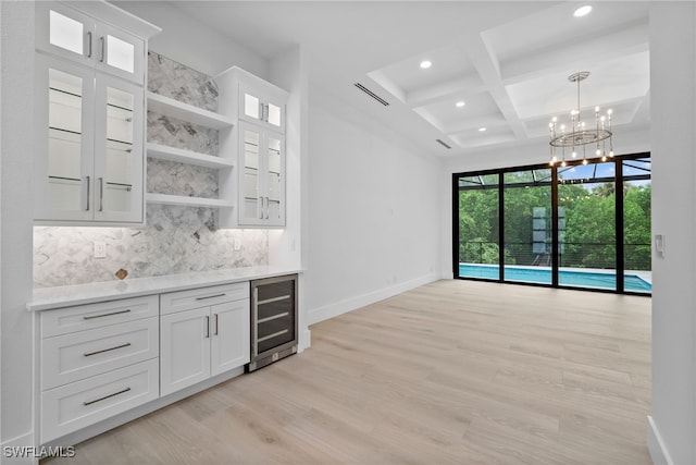 bar with coffered ceiling, wine cooler, white cabinets, and tasteful backsplash