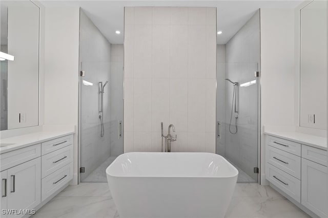 bathroom featuring vanity, independent shower and bath, and tile walls