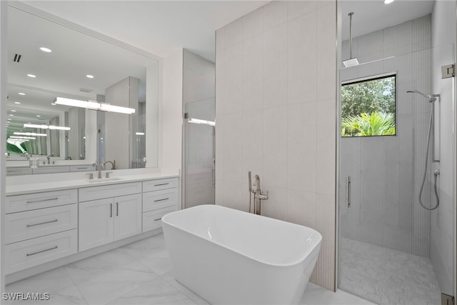 bathroom featuring plus walk in shower, tile walls, and vanity