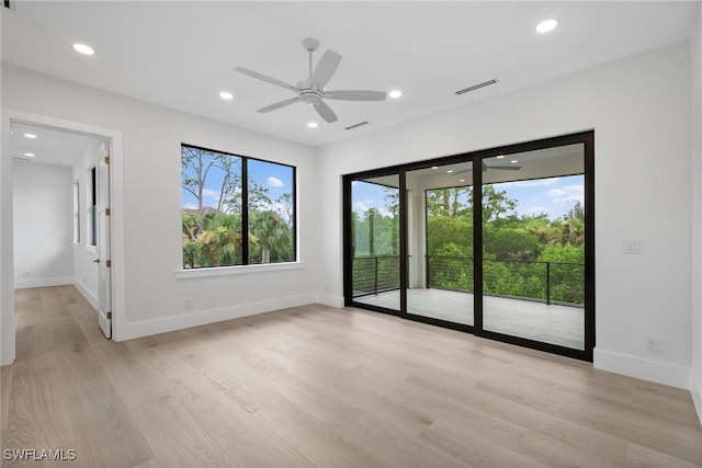 unfurnished room with recessed lighting, baseboards, visible vents, and light wood finished floors