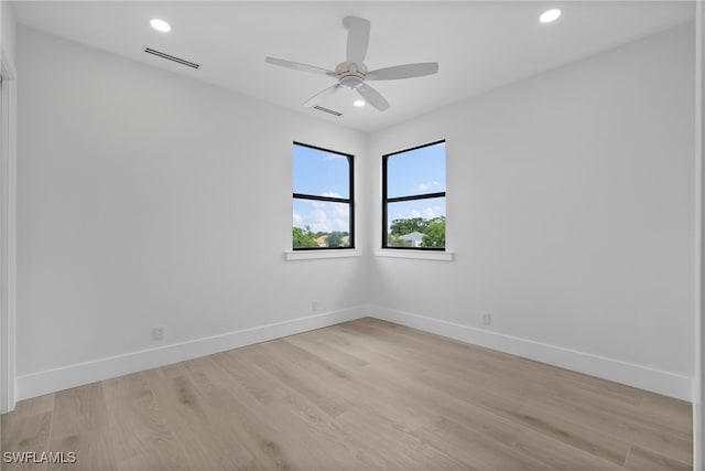 empty room with recessed lighting, visible vents, light wood-style flooring, and baseboards