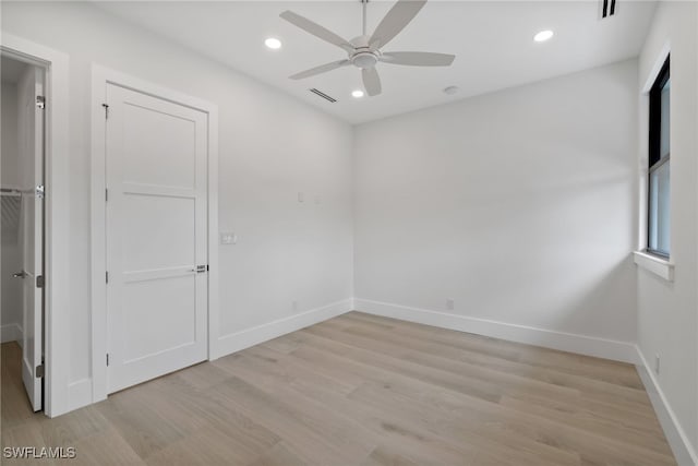 unfurnished room with light wood finished floors, recessed lighting, visible vents, and baseboards