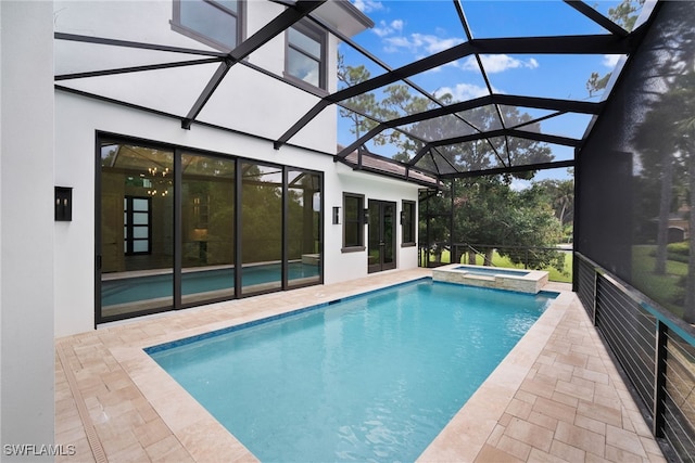 view of pool featuring a lanai, an in ground hot tub, and a patio area