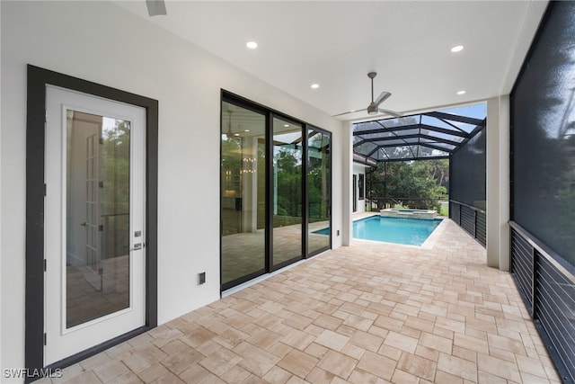 view of swimming pool featuring ceiling fan and a pool with connected hot tub