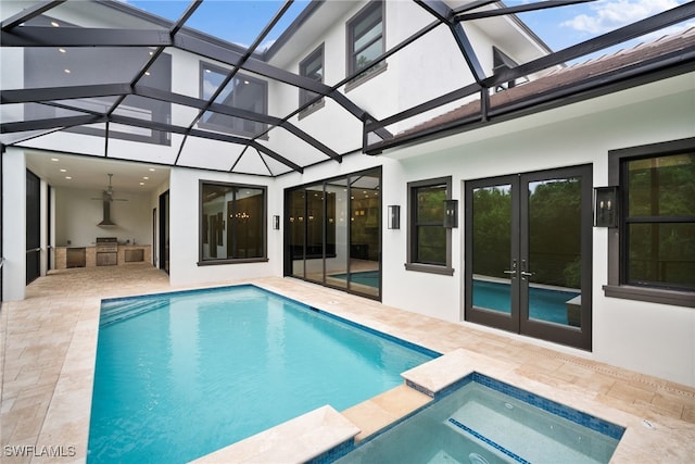 view of swimming pool featuring ceiling fan, a lanai, a patio area, and french doors