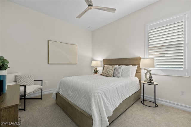 bedroom featuring multiple windows, light carpet, and ceiling fan