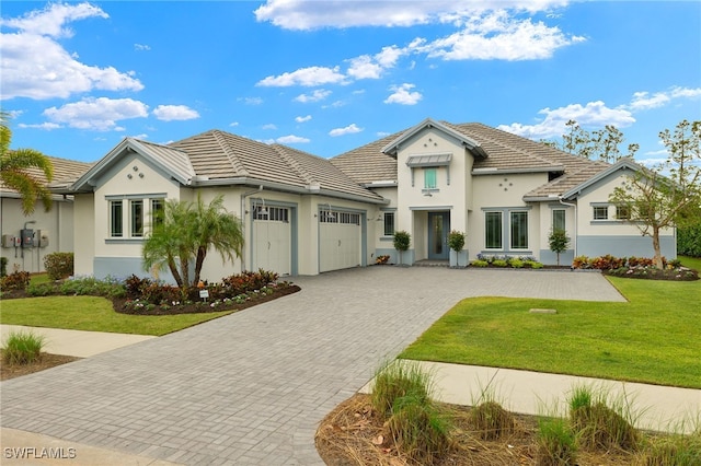 view of front of property featuring a garage and a front yard