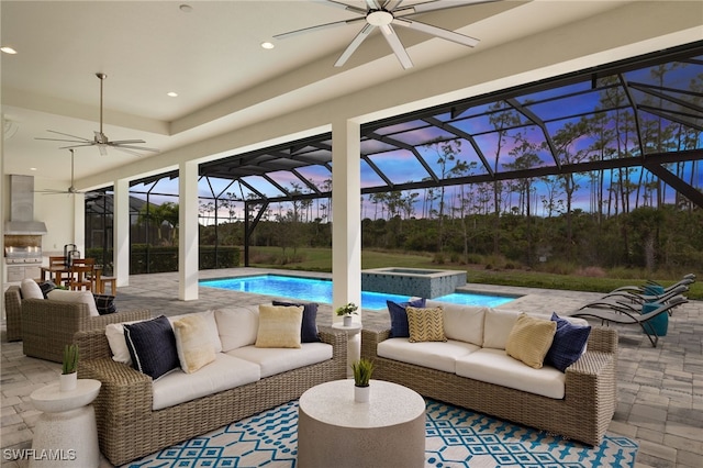 exterior space with an in ground hot tub, a patio, outdoor lounge area, a lanai, and ceiling fan