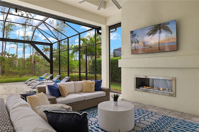 view of patio / terrace with outdoor lounge area, glass enclosure, and ceiling fan