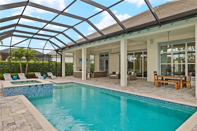 view of pool with glass enclosure, a patio, and an in ground hot tub