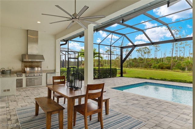 view of pool with ceiling fan, a lanai, area for grilling, and a patio area