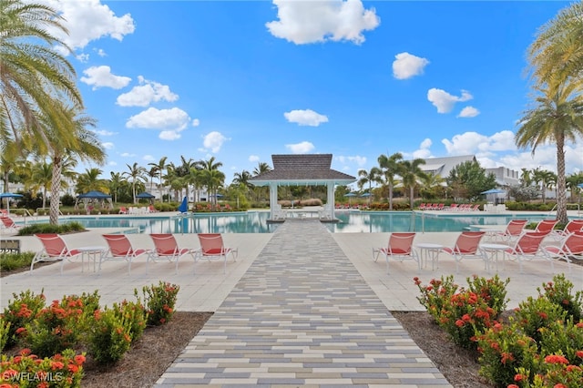 view of pool featuring a patio, a gazebo, and pool water feature