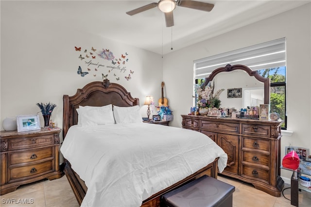 tiled bedroom featuring multiple windows and ceiling fan