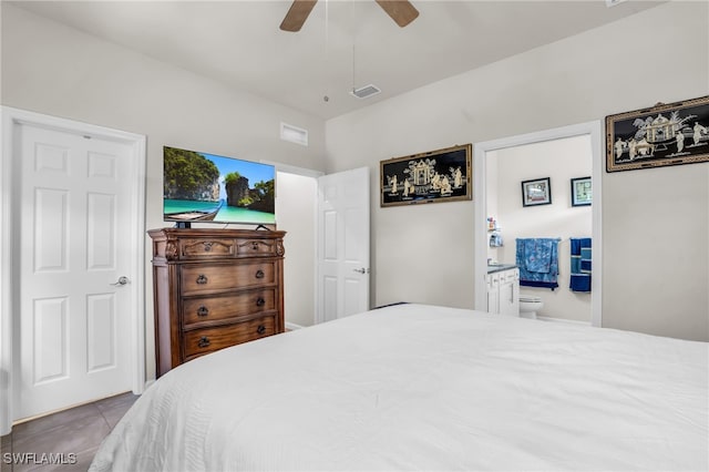 bedroom with ceiling fan, light tile patterned floors, and connected bathroom